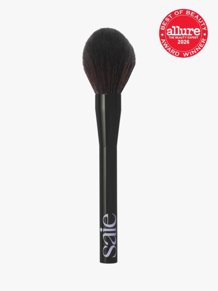 Saie The All-Over Powder Brush in branded component on a light gray background with the 2026 best of beauty seal in the top right corner